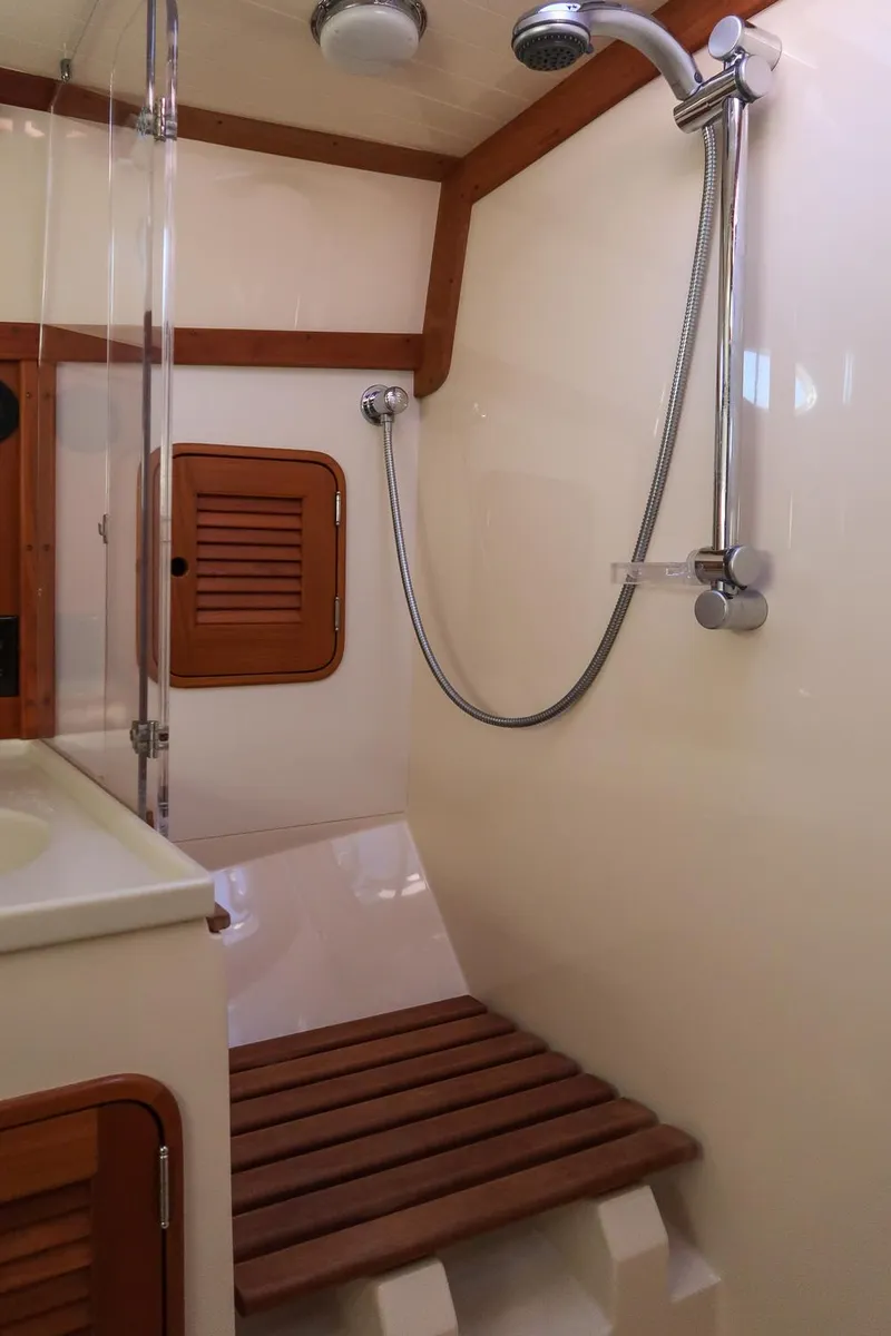 Slide: The Image of 2005 Hinckley Talaria 40 yacht bathroom with wooden cabinetry and modern fixtures. - 34
