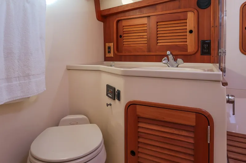 Slide: The Image of 2005 Hinckley Talaria 40 yacht interior with wooden cabinetry and modern fixtures. - 36