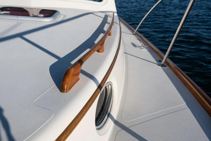 Slide: The Image of 2005 Hinckley Talaria 40 yacht deck with wooden accents and ocean backdrop. - 39