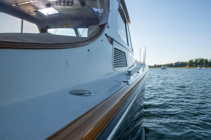 Slide: The Image of 2005 Hinckley Talaria 40 yacht on calm water, side view. - 40