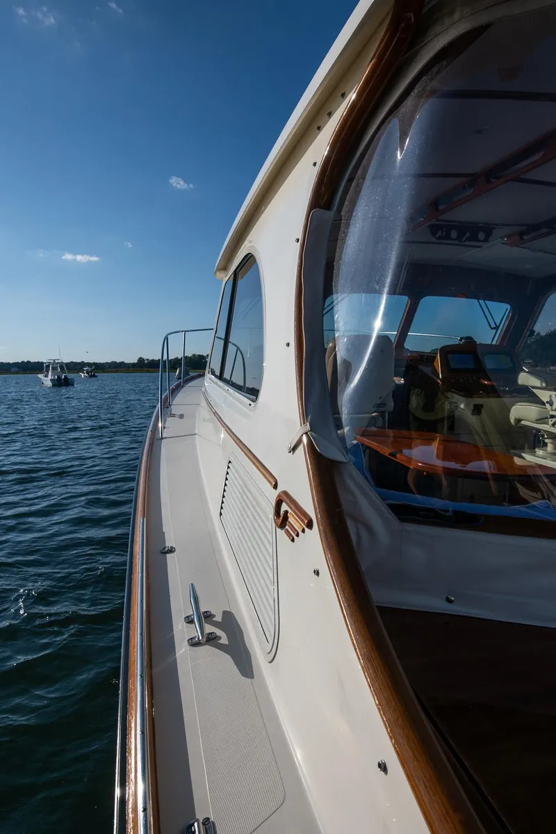 Slide: The Image of 2005 Hinckley Talaria 40 yacht on water, showcasing sleek design and luxurious interior. - 41