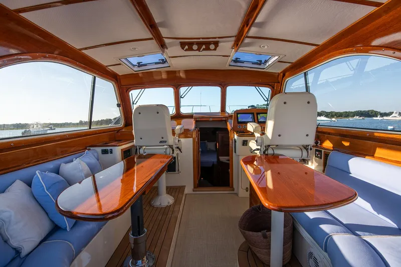 Slide: The Image of 2005 Hinckley Talaria 40 yacht on calm water, rear view with American flag. - 9