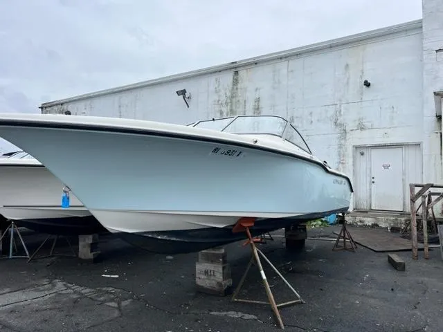 Slide: The Image of 2020 Key West 239 DFS boat on stands near a white building. - 1