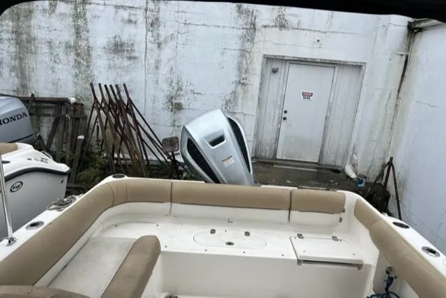 Slide: The Image of 2020 Key West 239 DFS boat interior with beige seating and Honda outboard motor. - 8