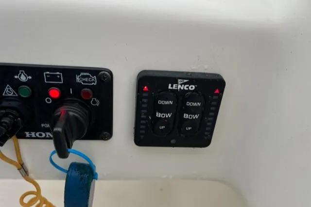 Slide: The Image of Key West 239 DFS 2020 boat control panel with Lenco trim tab switches. - 9