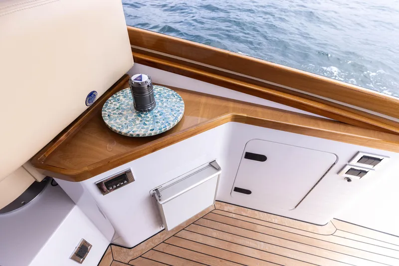 Slide: The Image of 2014 San Juan Open Express Cruiser deck with wooden trim and ocean view. - 14