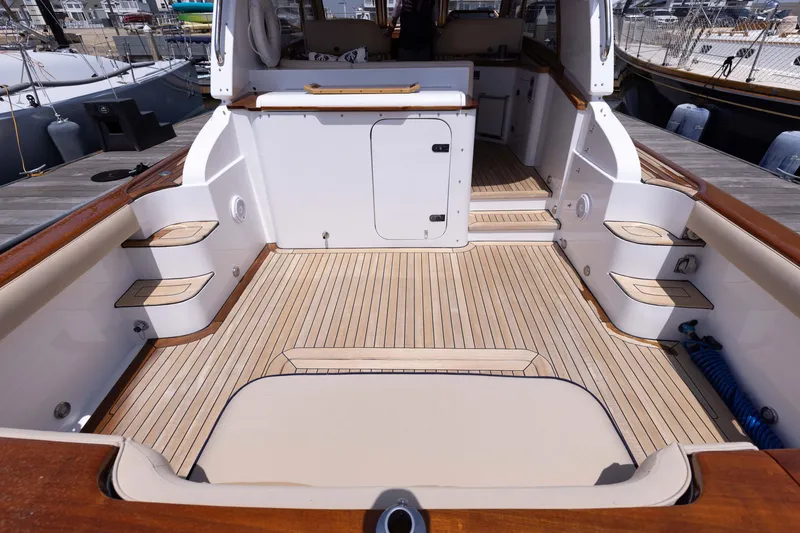 Slide: The Image of 2014 San Juan Open Express Cruiser boat deck with teak flooring and seating. - 15