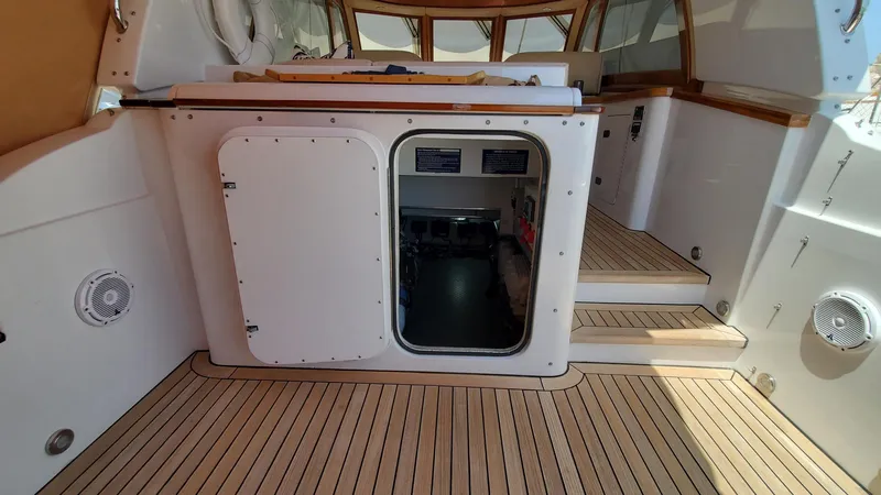 Slide: The Image of 2014 San Juan Open Express Cruiser interior with wooden flooring and steps. - 16