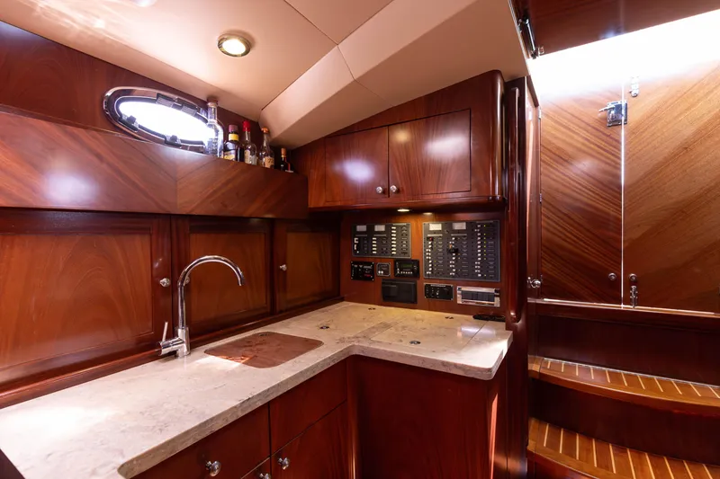 Slide: The Image of Luxurious 2014 San Juan Open Express Cruiser kitchen with wooden cabinetry and modern amenities. - 18