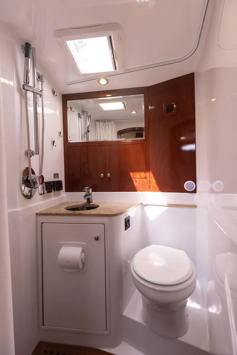 Slide: The Image of 2014 San Juan Open Express Cruiser bathroom with modern fixtures and wooden accents. - 22