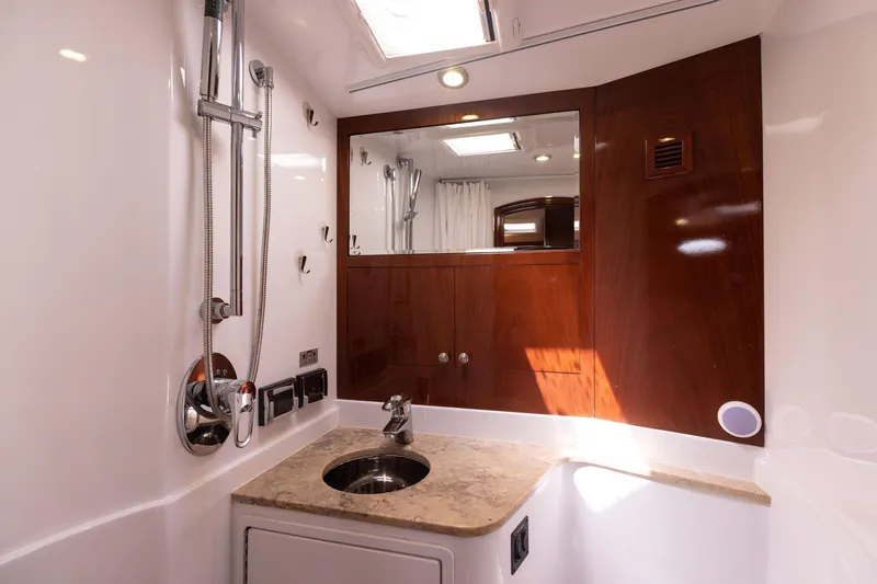 Slide: The Image of Luxurious bathroom in 2014 San Juan Open Express Cruiser with modern fixtures and wooden accents. - 25