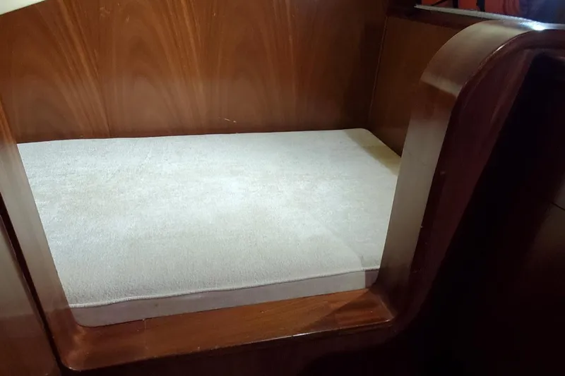 Slide: The Image of 2014 San Juan Open Express Cruiser interior seating with wooden frame and cushioned seat. - 32
