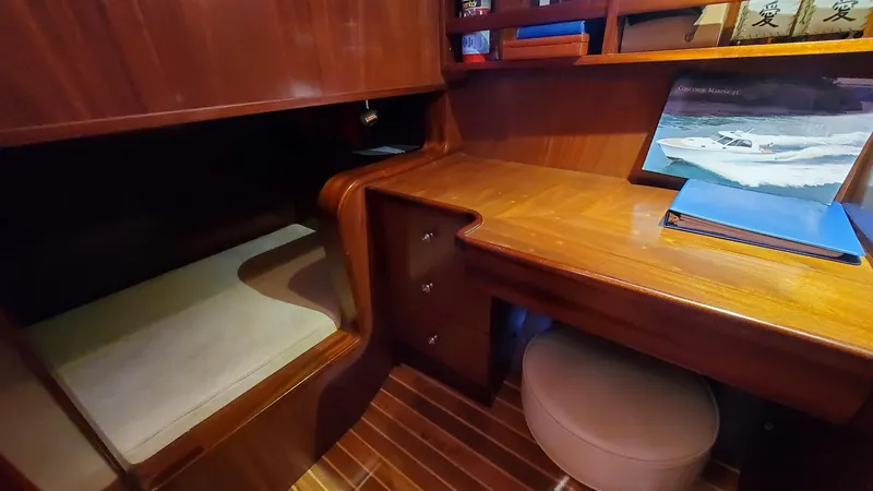 Slide: The Image of 2014 San Juan Open Express Cruiser cabin with wooden desk and bed. - 33