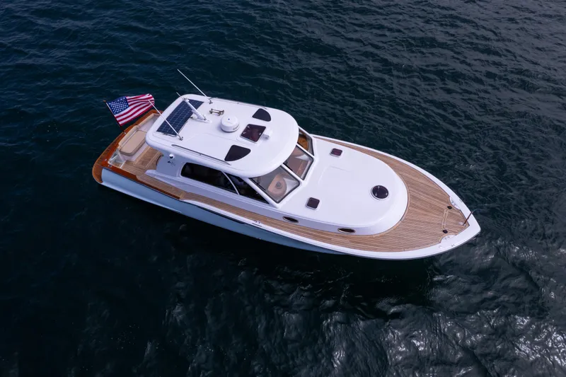 Slide: The Image of 2014 San Juan Open Express Cruiser on water with American flag. - 37