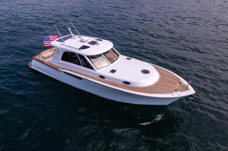Slide: The Image of 2014 San Juan Open Express Cruiser on the water with American flag. - 38