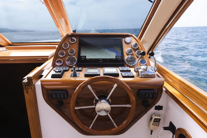 Slide: The Image of 2014 San Juan Open Express Cruiser helm with navigation system and wooden steering wheel. - 4