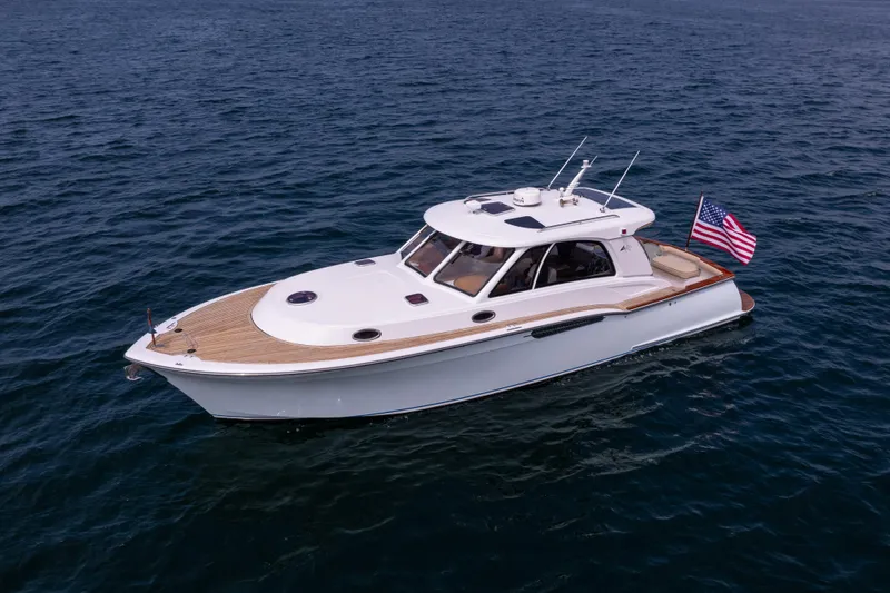 Slide: The Image of 2014 San Juan Open Express Cruiser on open water with American flag. - 40