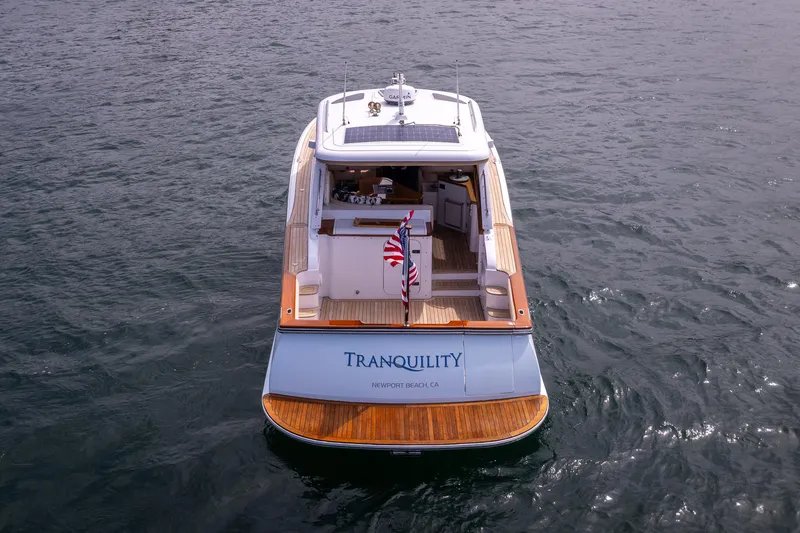 Slide: The Image of 2014 San Juan Open Express Cruiser Tranquility on water, rear view. - 41