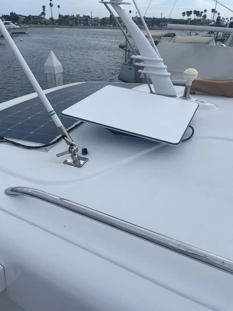 Slide: The Image of 2014 San Juan Open Express Cruiser with solar panel on deck, docked in marina. - 46