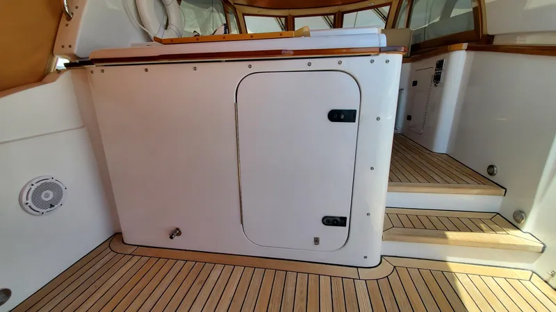 Slide: The Image of 2014 San Juan Open Express Cruiser interior with wooden flooring and white cabinetry. - 49