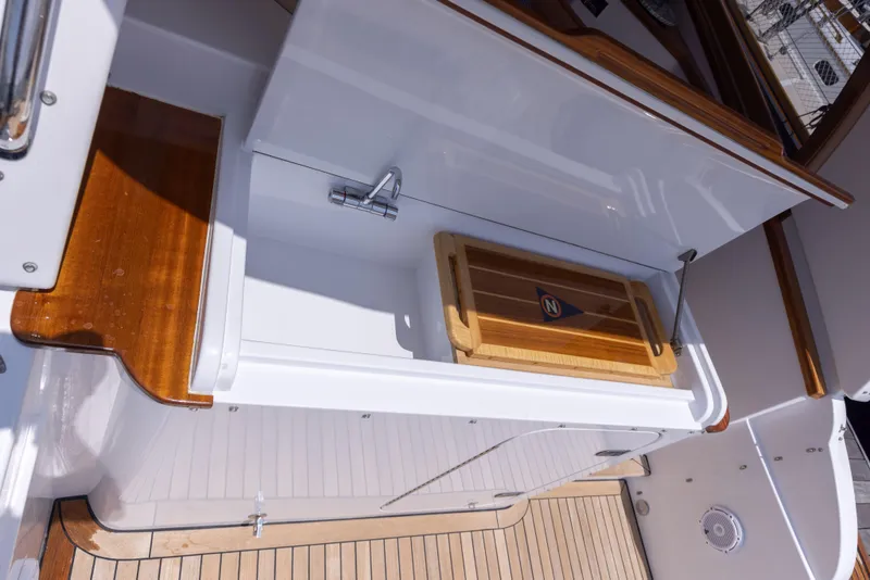 Slide: The Image of 2014 San Juan Open Express Cruiser with wooden deck and storage compartment. - 52