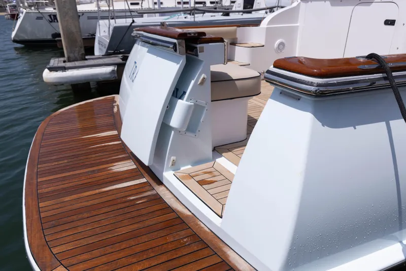 Slide: The Image of 2014 San Juan Open Express Cruiser with teak deck at marina. - 53