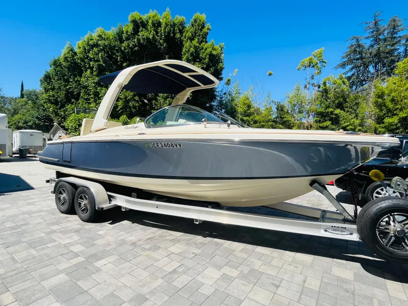 Slide: The Image of 2022 Chris-Craft Launch 25 GT boat on trailer, parked outdoors. - 1