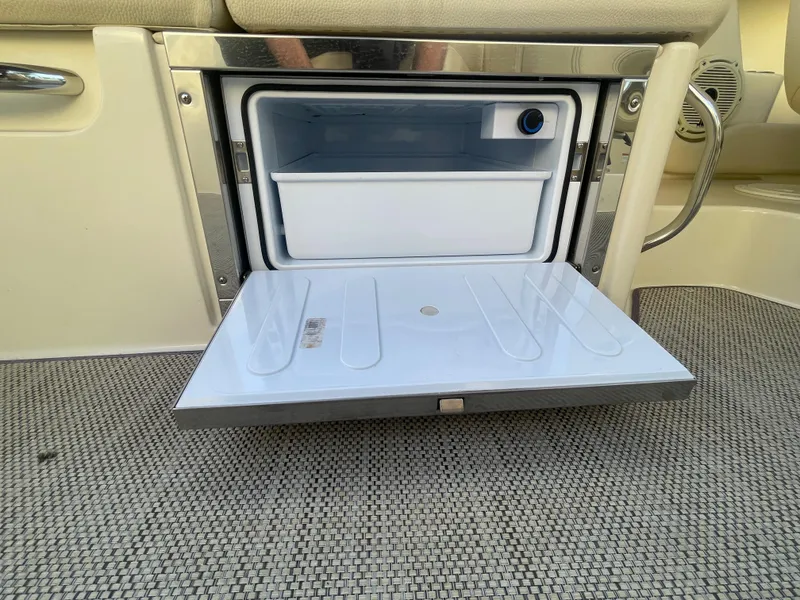 Slide: The Image of 2022 Chris-Craft Launch 25 GT boat with open built-in cooler compartment. - 11