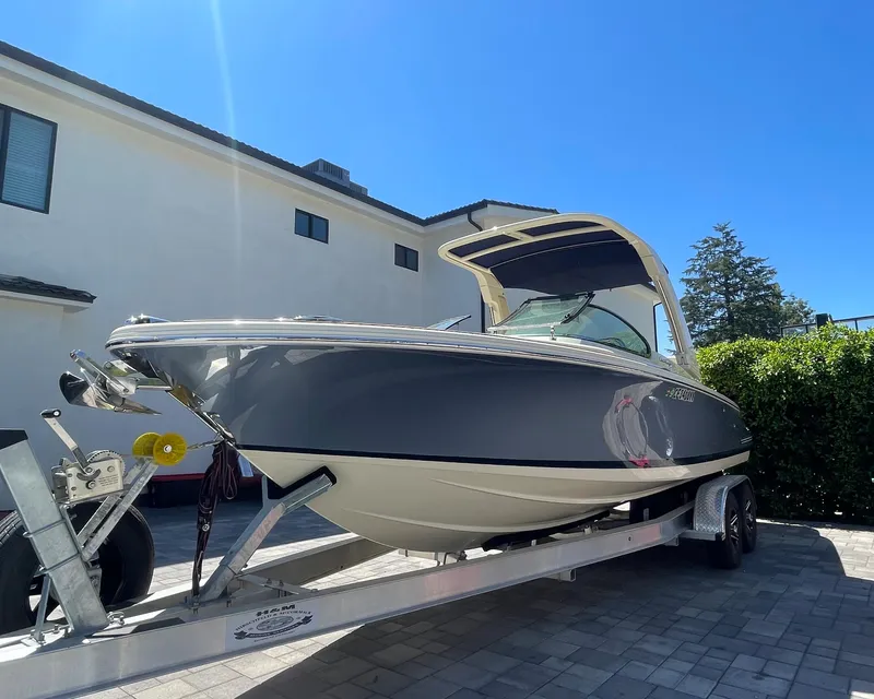 Slide: The Image of 2022 Chris-Craft Launch 25 GT boat on trailer, parked in driveway. - 2