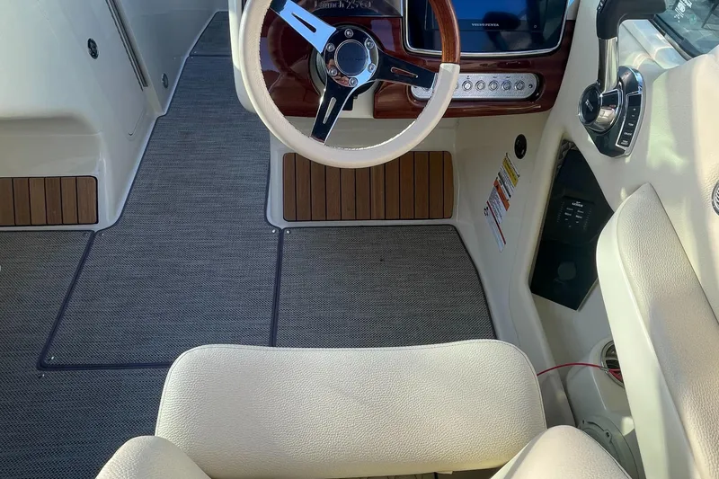 Slide: The Image of 2022 Chris-Craft Launch 25 GT interior with steering wheel and dashboard. - 5