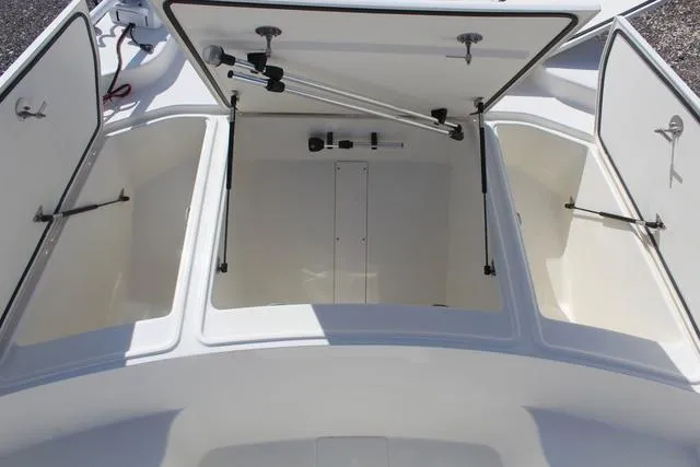 Slide: The Image of 2024 Mako Pro Skiff 19 CC storage compartment with dual access hatches. - 10