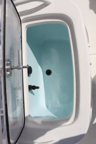 Slide: The Image of 2024 Mako Pro Skiff 19 CC interior view, showcasing seating and storage compartments. - 14