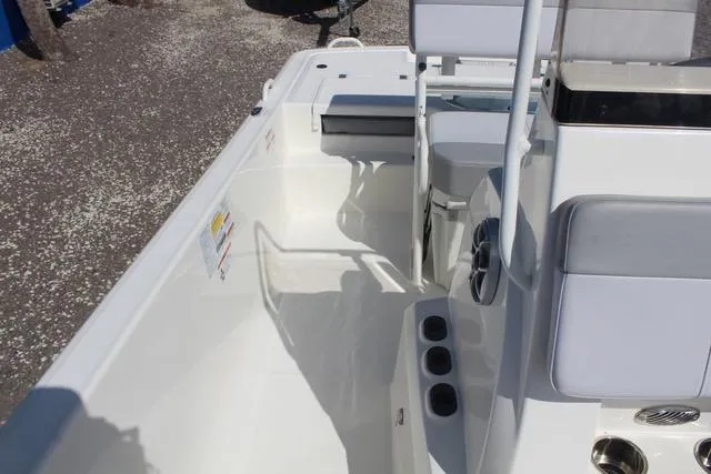 Slide: The Image of 2024 Mako Pro Skiff 19 CC interior view, featuring seating and steering console. - 15