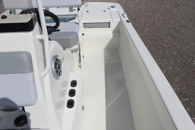 Slide: The Image of 2024 Mako Pro Skiff 19 CC center console with steering wheel and control panel. - 16