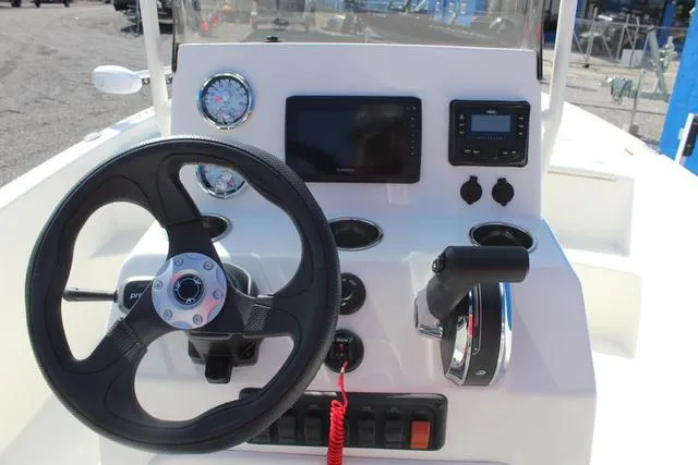 Slide: The Image of 2024 Mako Pro Skiff 19 CC battery compartment with wiring and switches. - 17