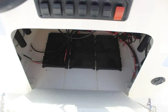 Slide: The Image of 2024 Mako Pro Skiff 19 CC boat interior with cushioned seating and steering console. - 18