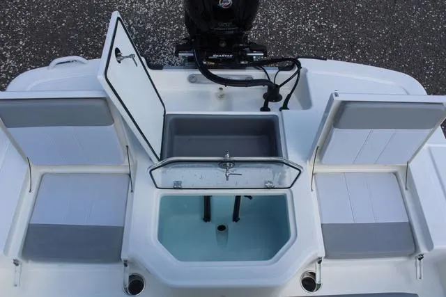 Slide: The Image of 2024 Mako Pro Skiff 19 CC center console seating with cooler storage. - 21