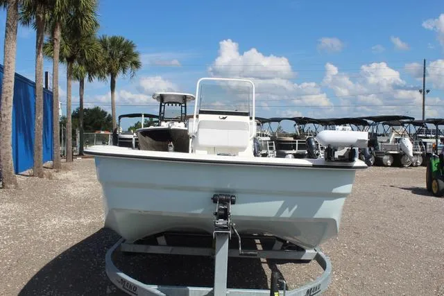 Slide: The Image of 2024 Mako Pro Skiff 19 CC on trailer in a boatyard. - 3