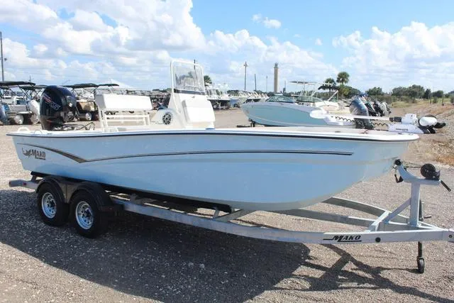 Slide: The Image of 2024 Mako Pro Skiff 19 CC boat on trailer with outboard motor. - 4