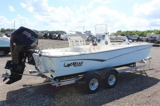 Slide: The Image of 2024 Mako Pro Skiff 19 CC boat on trailer, rear view with outboard motor. - 5