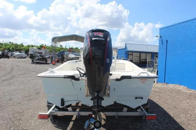 Slide: The Image of 2024 Mako Pro Skiff 19 CC boat on a trailer with outboard motor. - 6