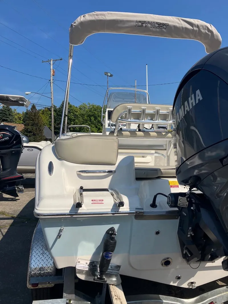 Slide: The Image of 2024 Key West 203 FS boat with Yamaha engine, parked outdoors. - 3