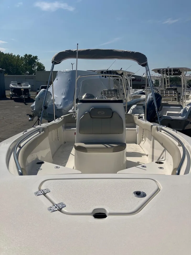 Slide: The Image of 2024 Key West 203 FS boat with canopy, docked under clear blue sky. - 6