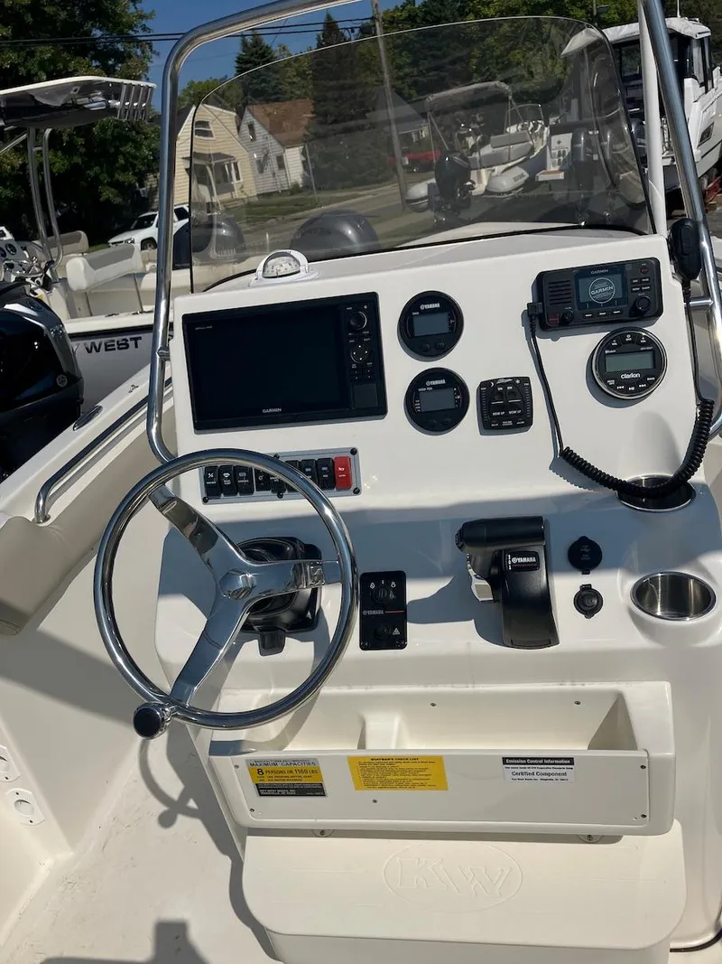 Slide: The Image of 2024 Key West 203 FS boat dashboard with steering wheel and navigation controls. - 7