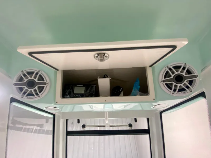 Slide: The Image of 2024 Robalo R270 boat interior storage compartment with speakers. - 23