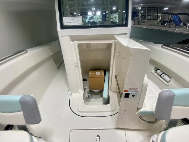 Slide: The Image of 2024 Robalo R270 boat interior with open storage compartment. - 26
