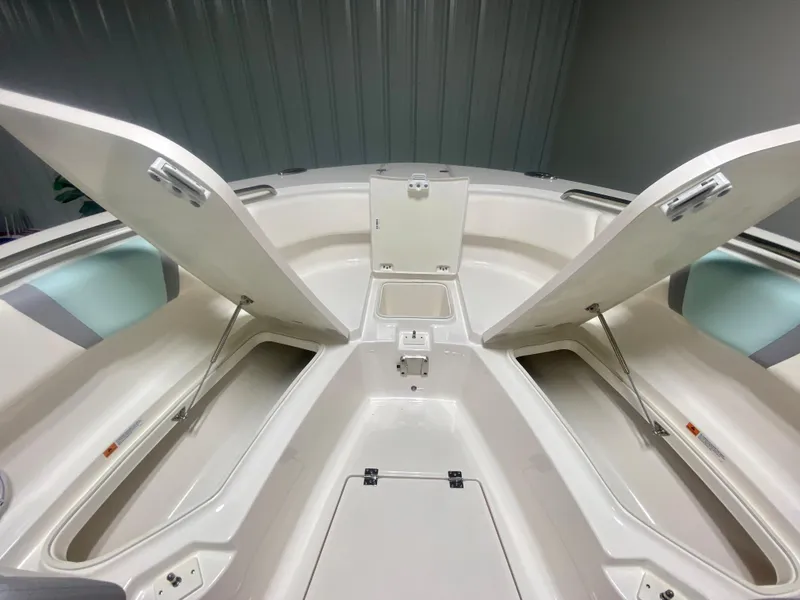 Slide: The Image of 2024 Robalo R270 boat interior storage compartments open. - 32
