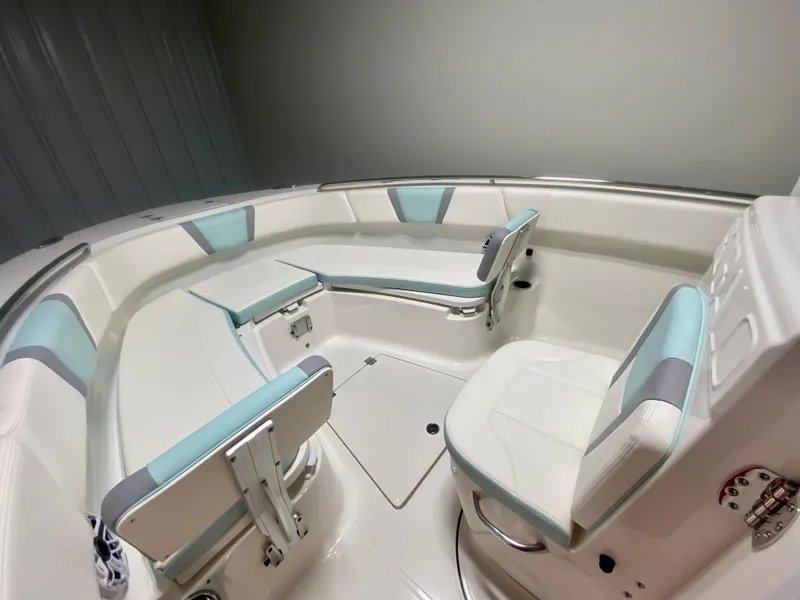 Slide: The Image of 2024 Robalo R270 boat interior with white and teal seating arrangement. - 33