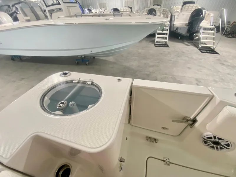 Slide: The Image of 2024 Robalo R270 boat interior, featuring storage compartments and a livewell. - 14