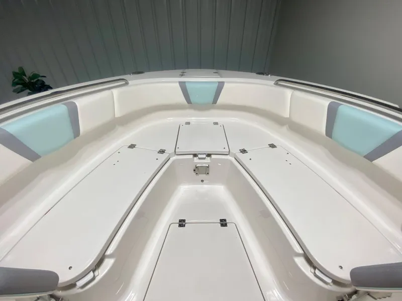 Slide: The Image of 2024 Robalo R270 boat interior with white and light blue seating. - 29
